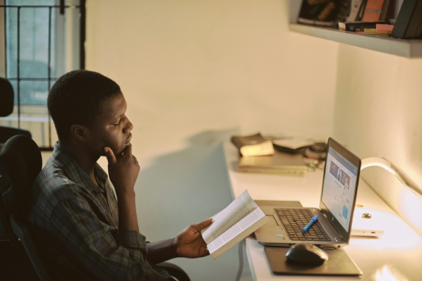 Student reading abook in dorm room