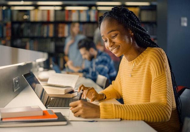 Student using a laptop in a library